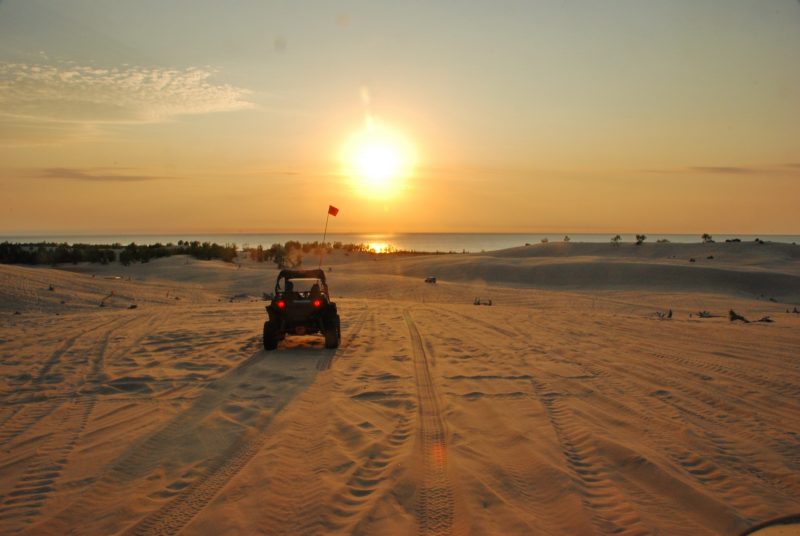 Buggy on the dunes at sunset