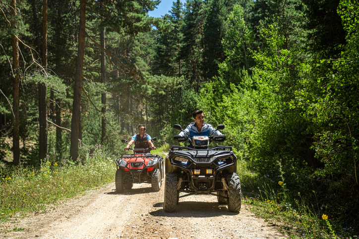 People riding ATVs on trails